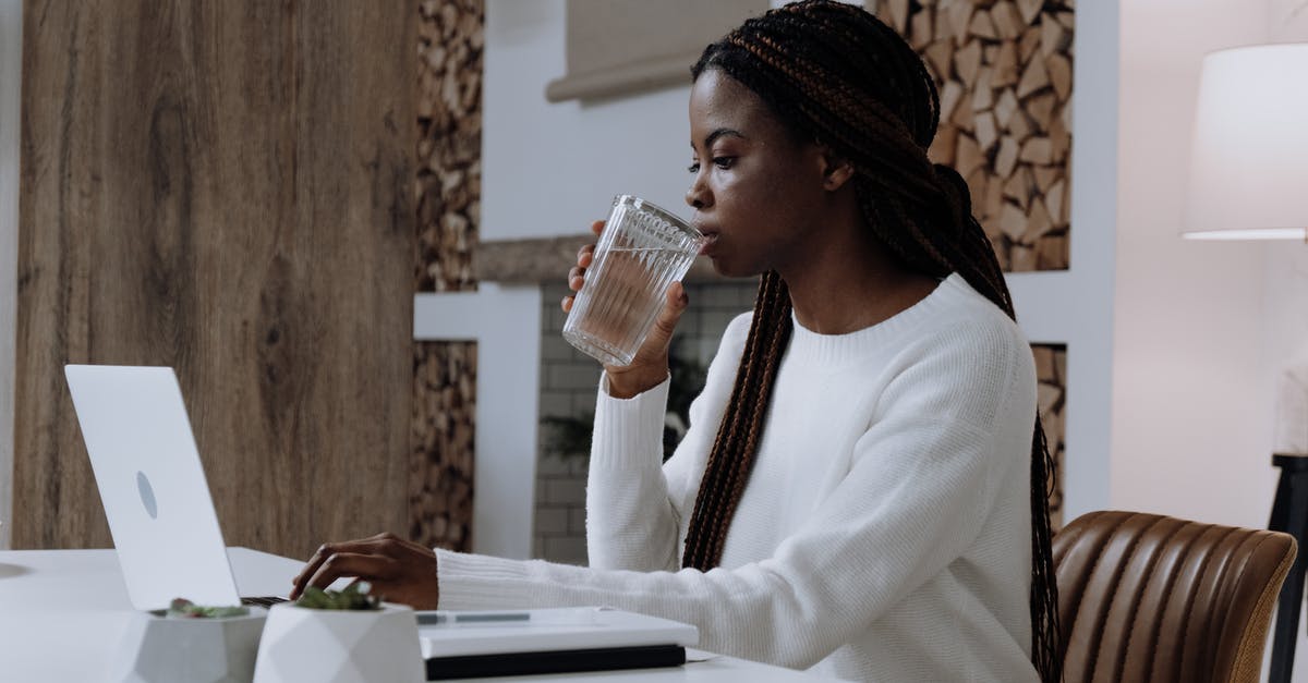 How does lentils' nutritional profile change in germinating lentils in water? - Woman in White Long Sleeve Shirt Sitting at the Table