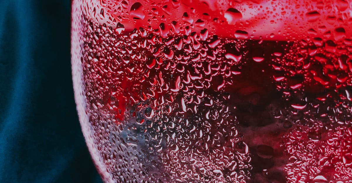 How does red wine butter impact the flavor of dishes? - Closeup of water drops on misted glass of cold red fizzy cocktail served on table