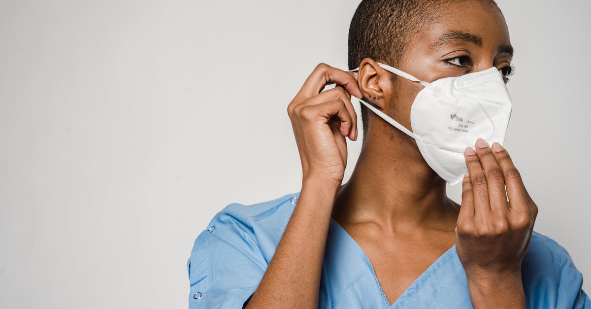 How does removing the germ of garlic help with breath/digestion? - African American female doctor putting on protective mask