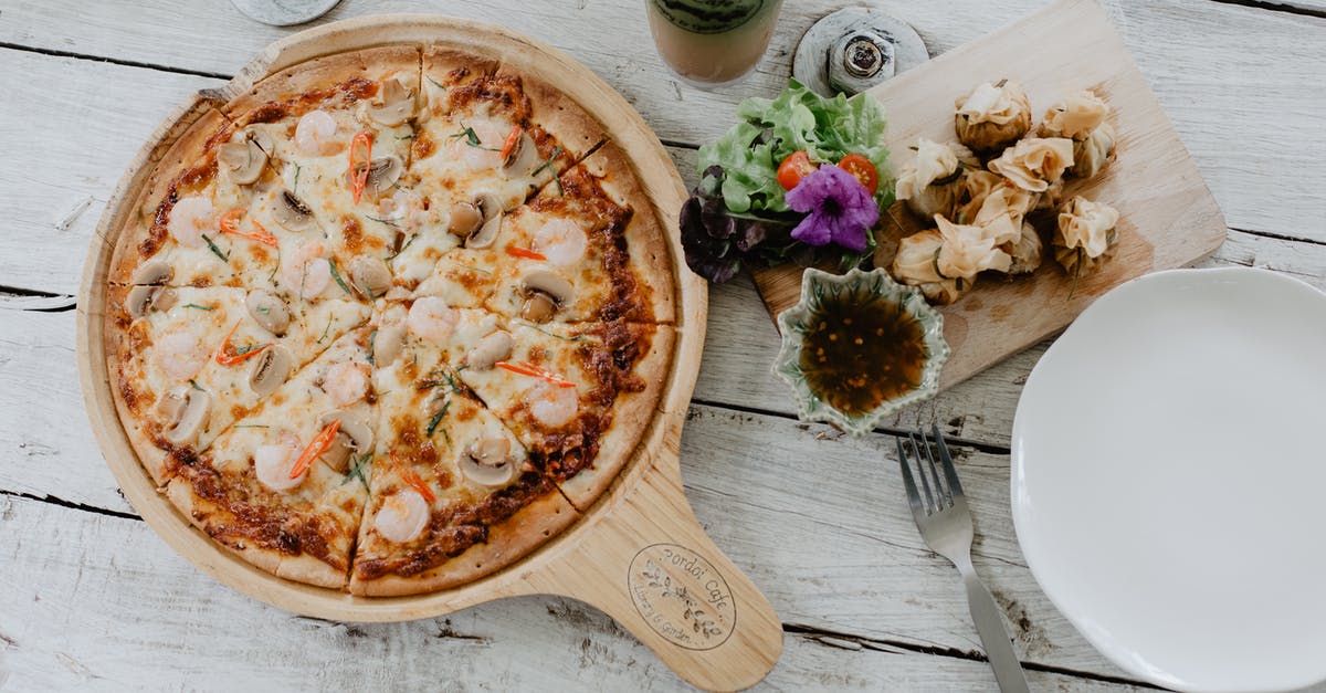 How heavy should a Chinese chef's knife be? - Pizza and dim sum on table in cafe