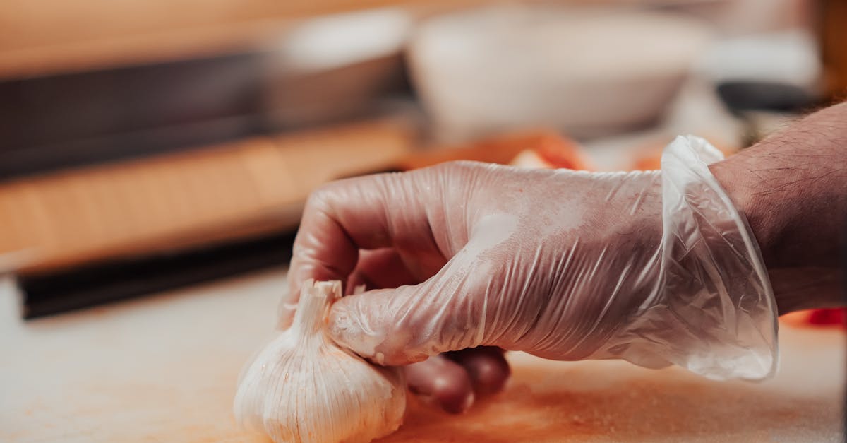 How heavy should a Chinese chef's knife be? - Person Holding White Cotton on Brown Wooden Table