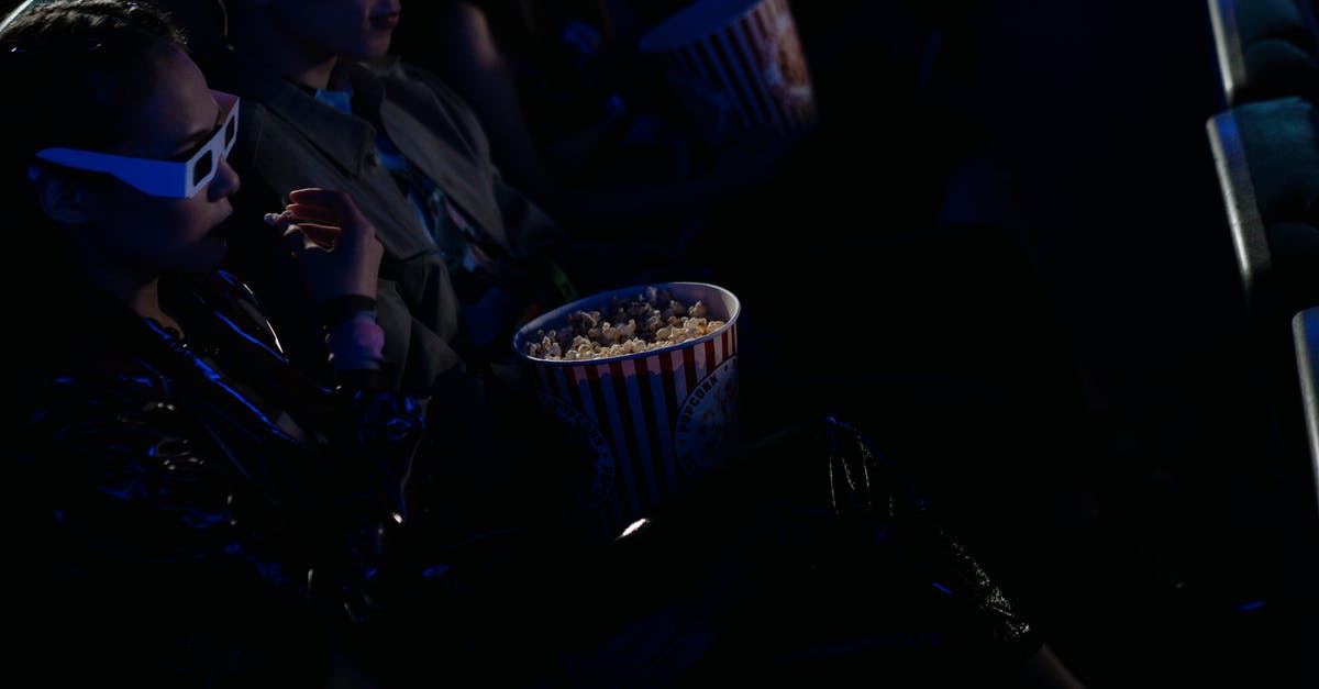 How Is Microwave Popcorn Flavoured? - Man in Black Suit Jacket Holding Cup