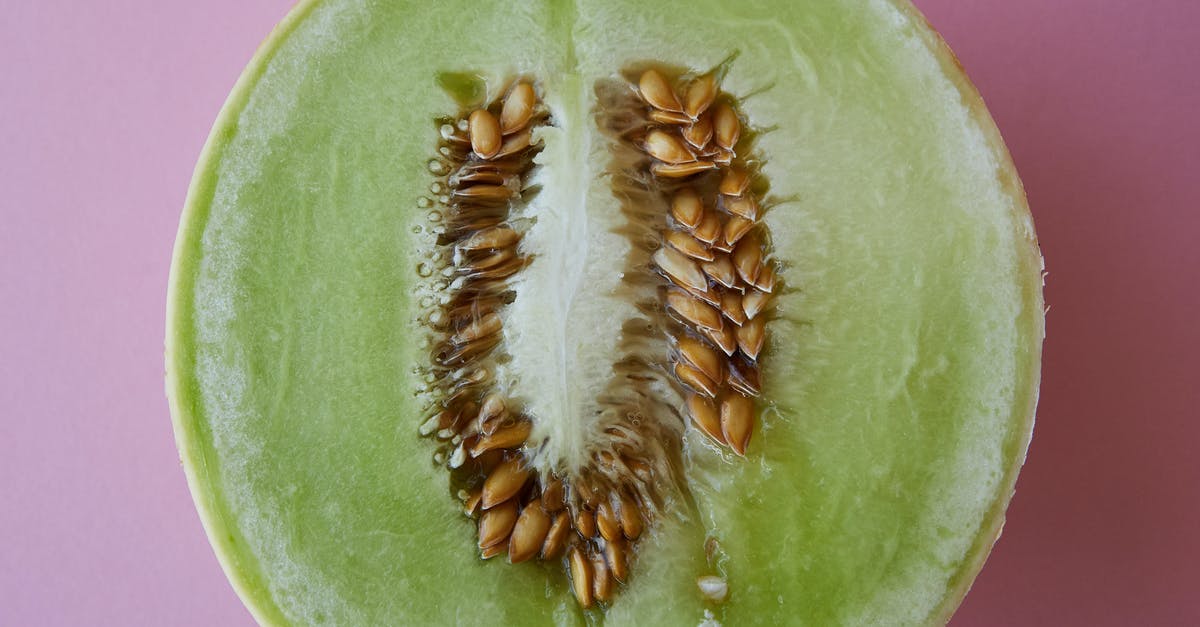 How is one meant to treat fenugreek seeds? - Top view of fresh half cut melon with seeds placed on pink background