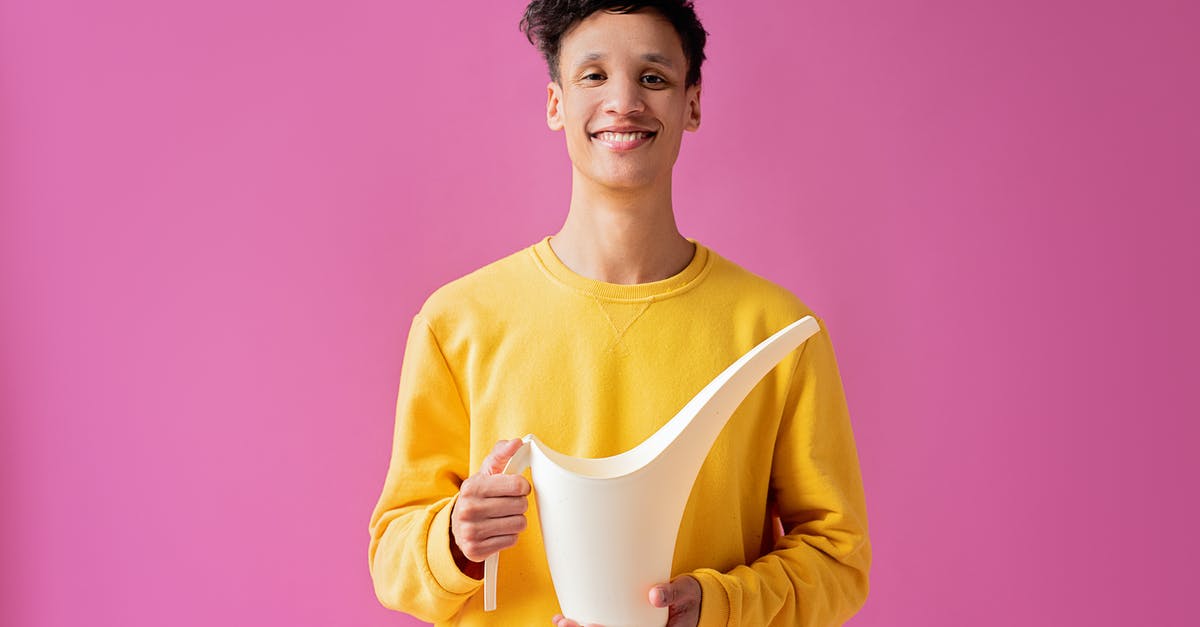 How long and how can I hold meringue before macaronage? - A Handsome Young Man Holding a Long Spout Plastic Watering Can