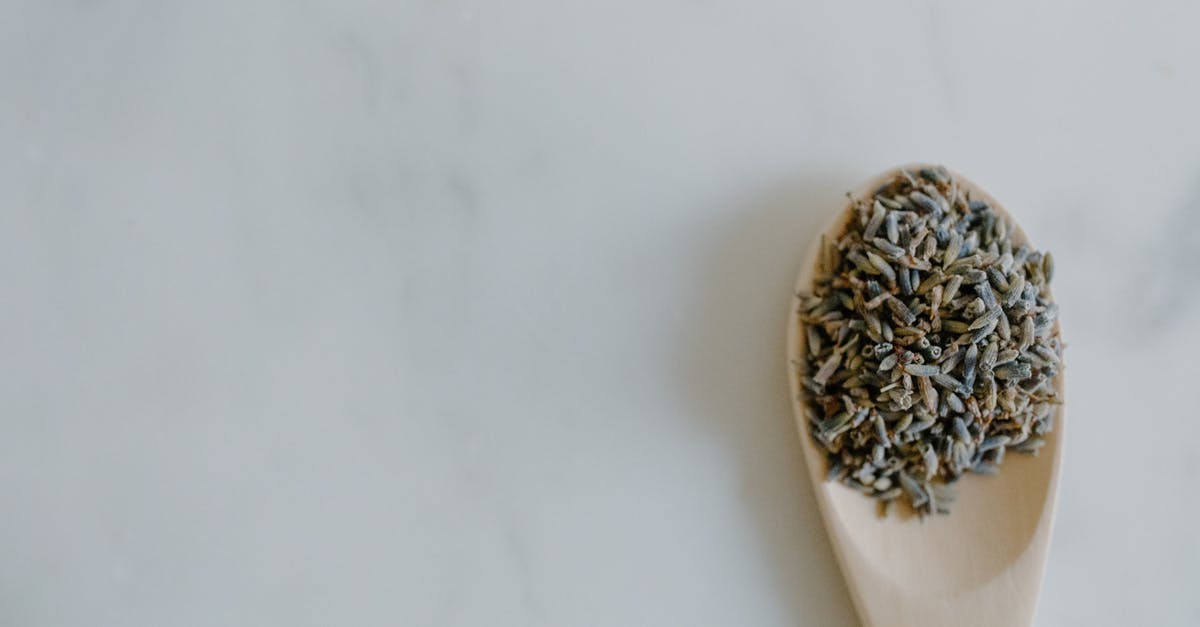 How long can home dried herbs be stored? - Top view of dried lavender in spoon placed on white marble surface in light room