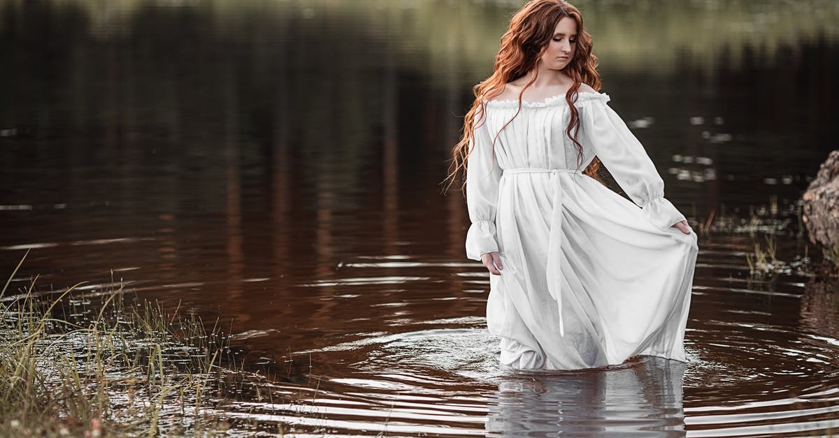 How long can I keep pureed root ginger - Gorgeous female with long ginger hair and in white elegant dress standing in water and looking down in daylight