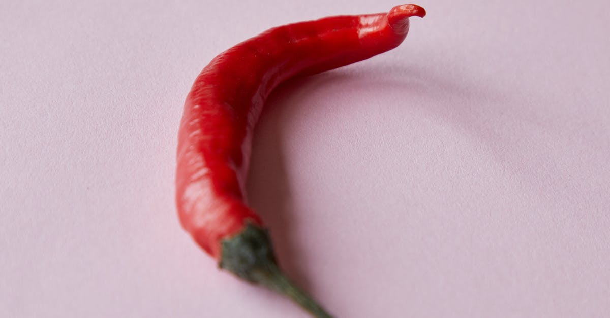 How long can I leave a vegan chili simmering without components breaking down? - Fresh ripe red chili pepper placed on white surface How long can I leave a vegan chili simmering without components breaking down? - Fresh ripe red chili pepper placed on white surface