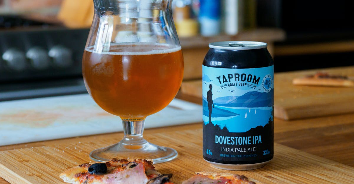 How long can leftover pizza be stored in the freezer? - Blue and White Labeled Pack Beside Clear Drinking Glass on Brown Wooden Table