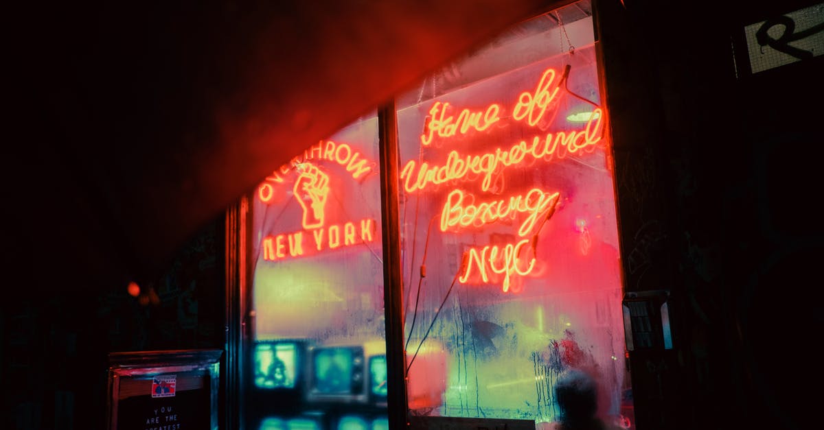 How long can we store honey in the home? [duplicate] - Exterior of shop with shiny neon inscriptions and vintage TV sets on street in late evening