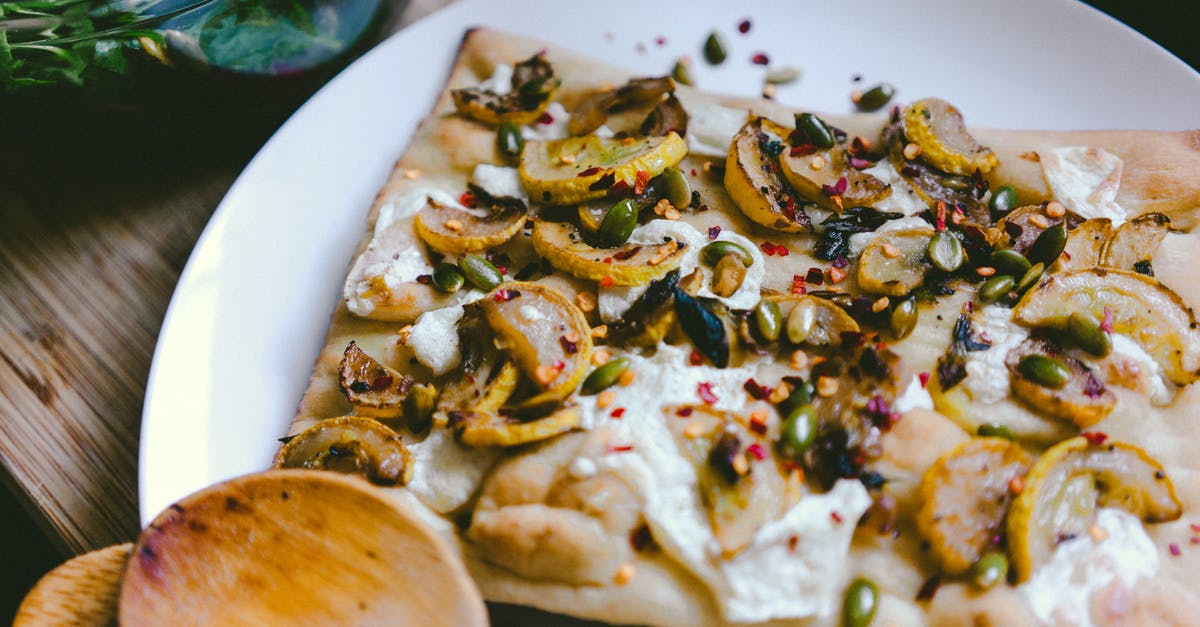 How long does cooked garlic keep in fridge? - Pizza Slice on White Ceramic Plate