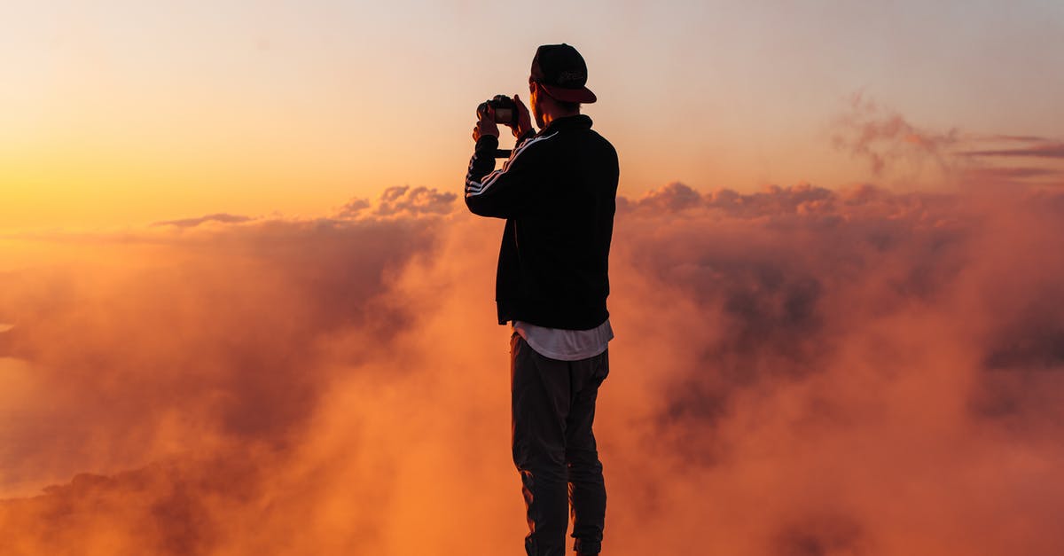 How long does it take to smoke a chicken? - Man in Black Shirt and Pants Standing on Rock during Sunset