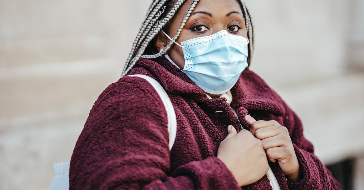How long is it safe to marinate meat? - Black female in mask outdoors in epidemic