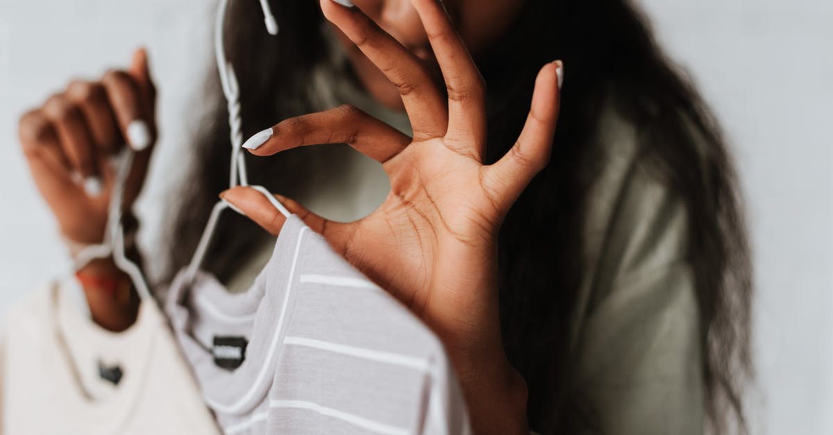 How long is SPAM really good for? - Crop young African American female with wear on hangers demonstrating good gesture on light background