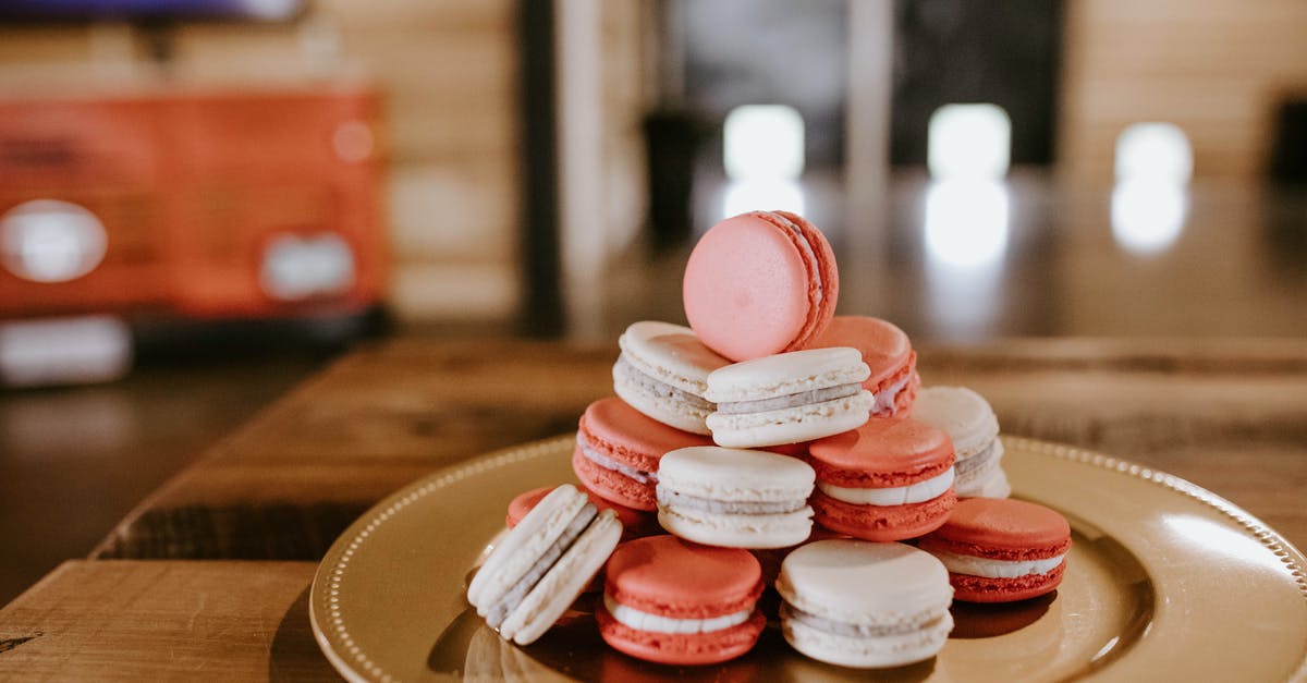 How long should I bake a whole sweet potato for? - Delicious sweet macaroons with cream filling stacked on plate for dessert on wooden table