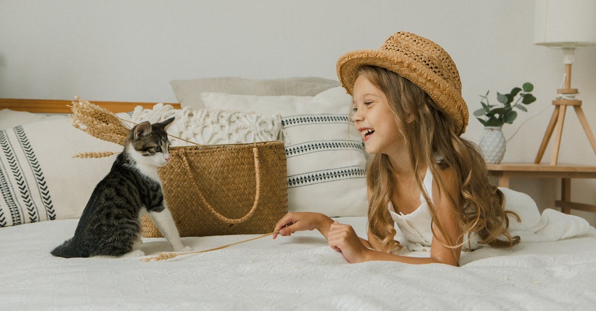 How long should I let durian ripen in a freezer bag? - Photo of a Cat and Girl in a Hat Lying on Bed