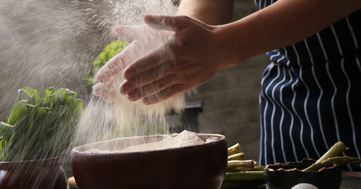 How long to cook asparagus on a BBQ? - Faceless woman dusting hands with flour during cooking process