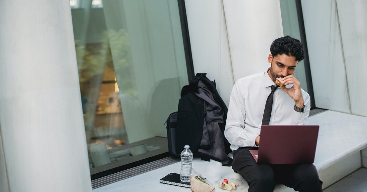 How long will a peanut butter sandwich last? - 
A Bearded Man in a Corporate Attire Eating while Using His Laptop