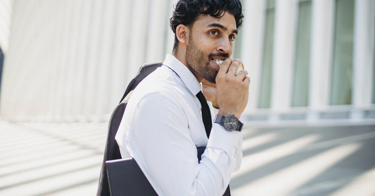 How long will a peanut butter sandwich last? - 
A Bearded Man in a Corporate Attire Eating a Sandwich