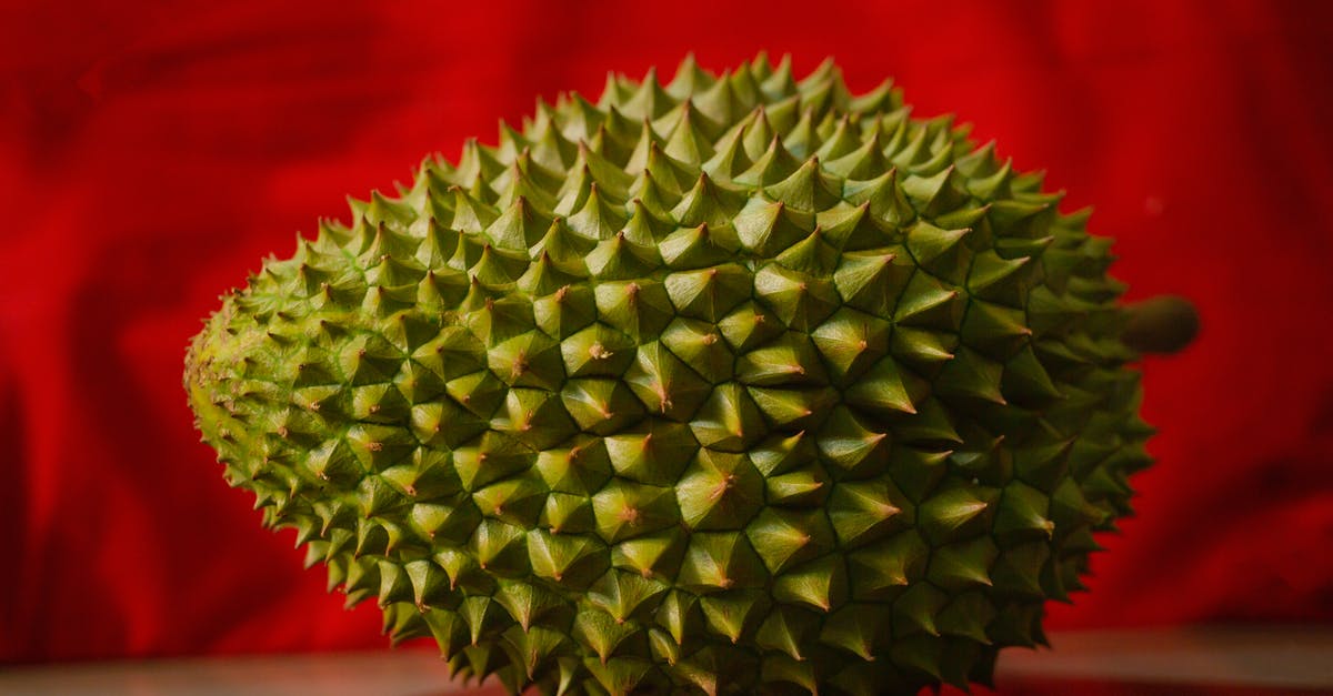 How long will durian smell linger? - Fresh prickly durian on red background