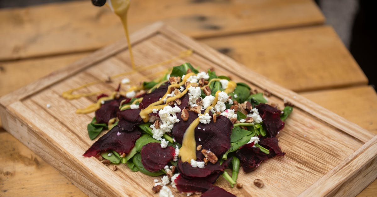 How long will homemade salad dressing stay good in the fridge? - Cheerful couple cooking dinner in kitchen