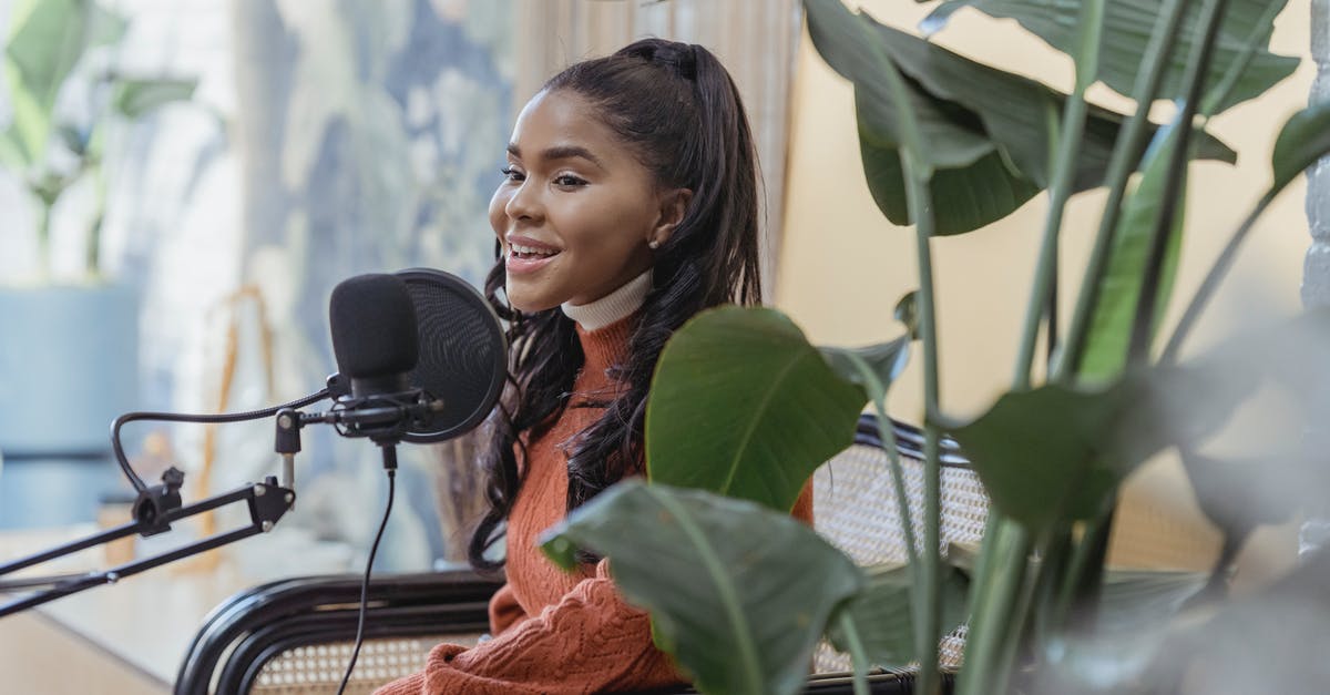 How long will live lobsters last in the fridge? - Happy young black woman singing during radio program