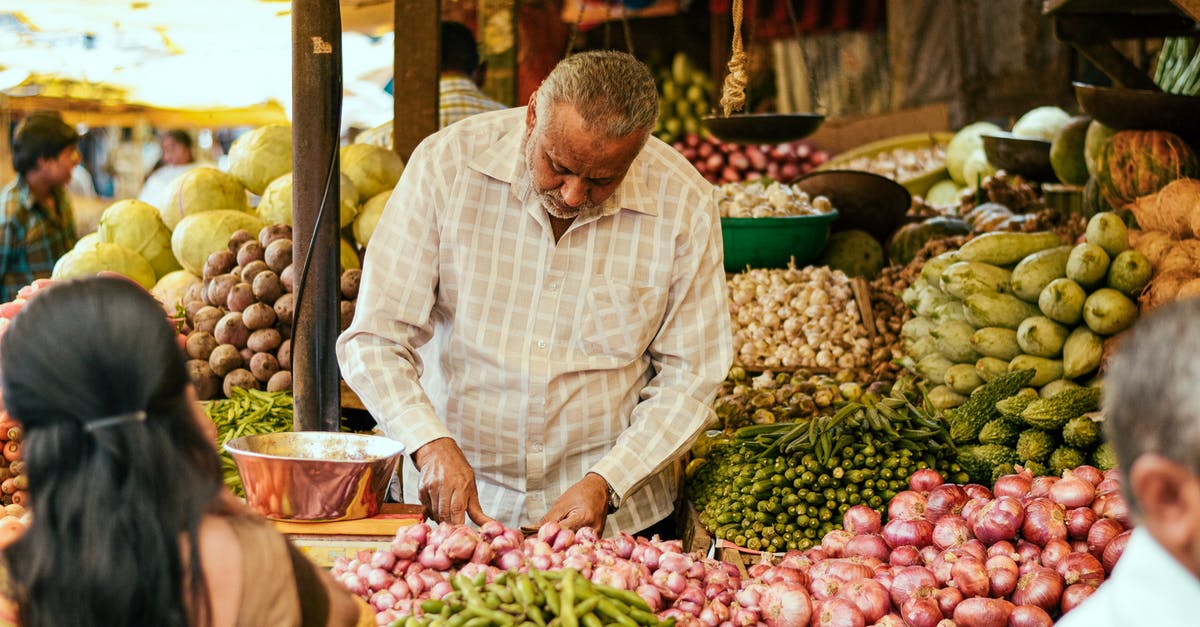 How many average onions are there per pound? - Ethnic seller working at local bazaar with vegetables