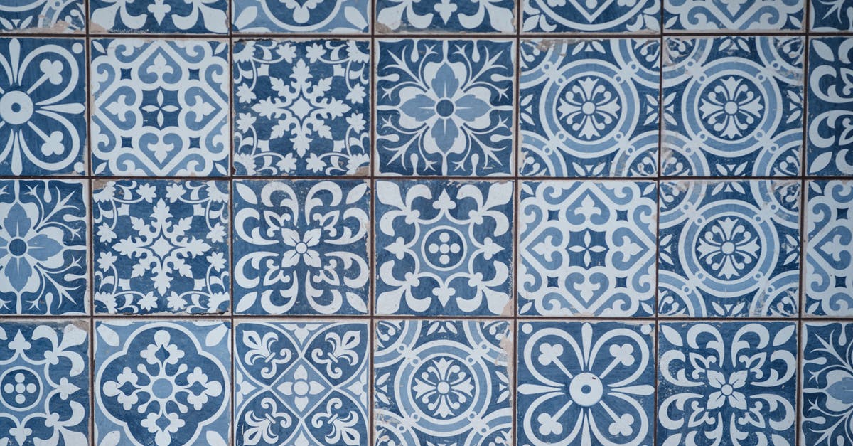 How many ceramic knives do I want? - Aged wall covered with ceramic square shaped tile with many blue different ornaments