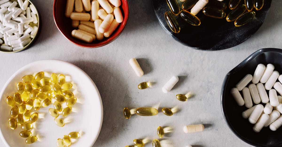 How many grams of gelatin are in stock/broth? - Top view of various types of gelatin coated drugs placed in bowls on stand and between plates on gray tabletop