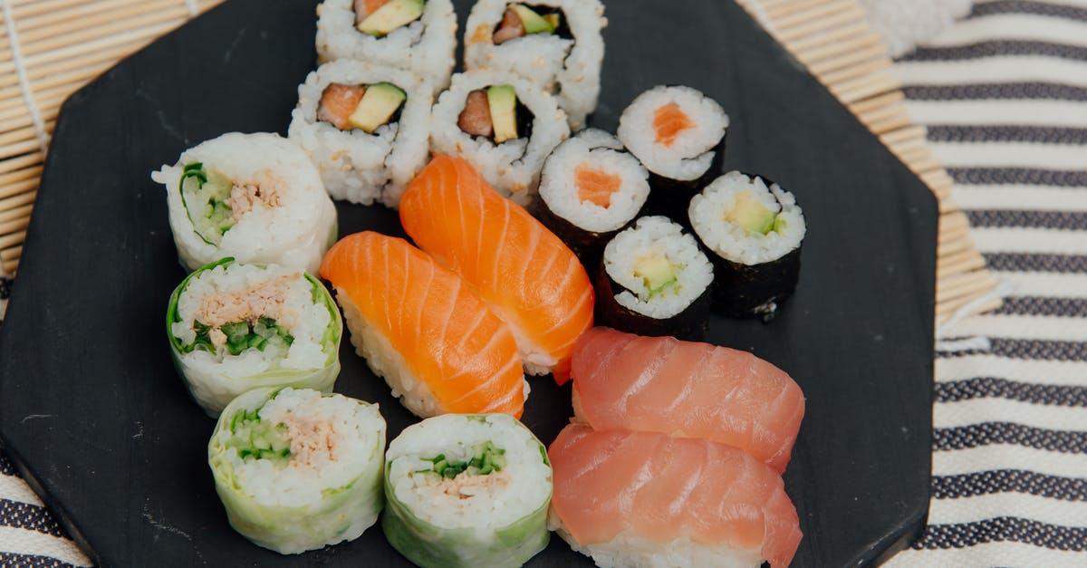 How many grams of Saffron for Rice? - From above of black table with various rolls and sushi with fresh salmon placed on table with rolling bamboo mat