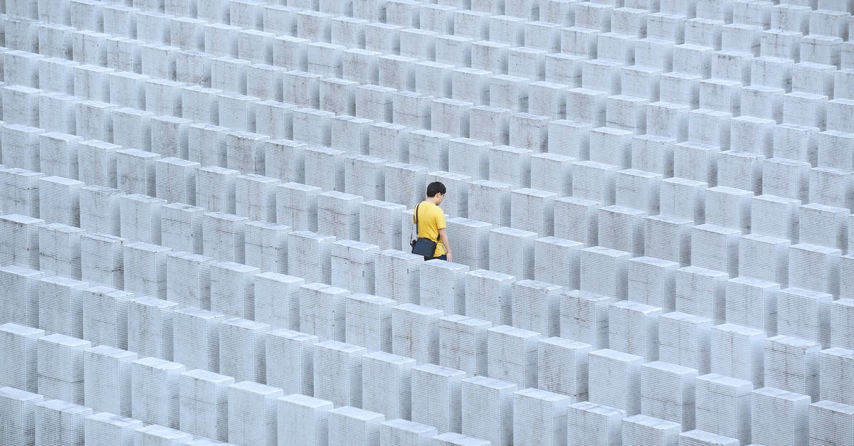 How many people does one rabbit feed? - Person in Yellow Jacket Walking on Gray Concrete Pavement