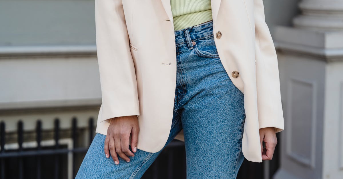 How much is a sleeve of celery? - Crop anonymous trendy female in beige jacket and jeans standing in town in daylight