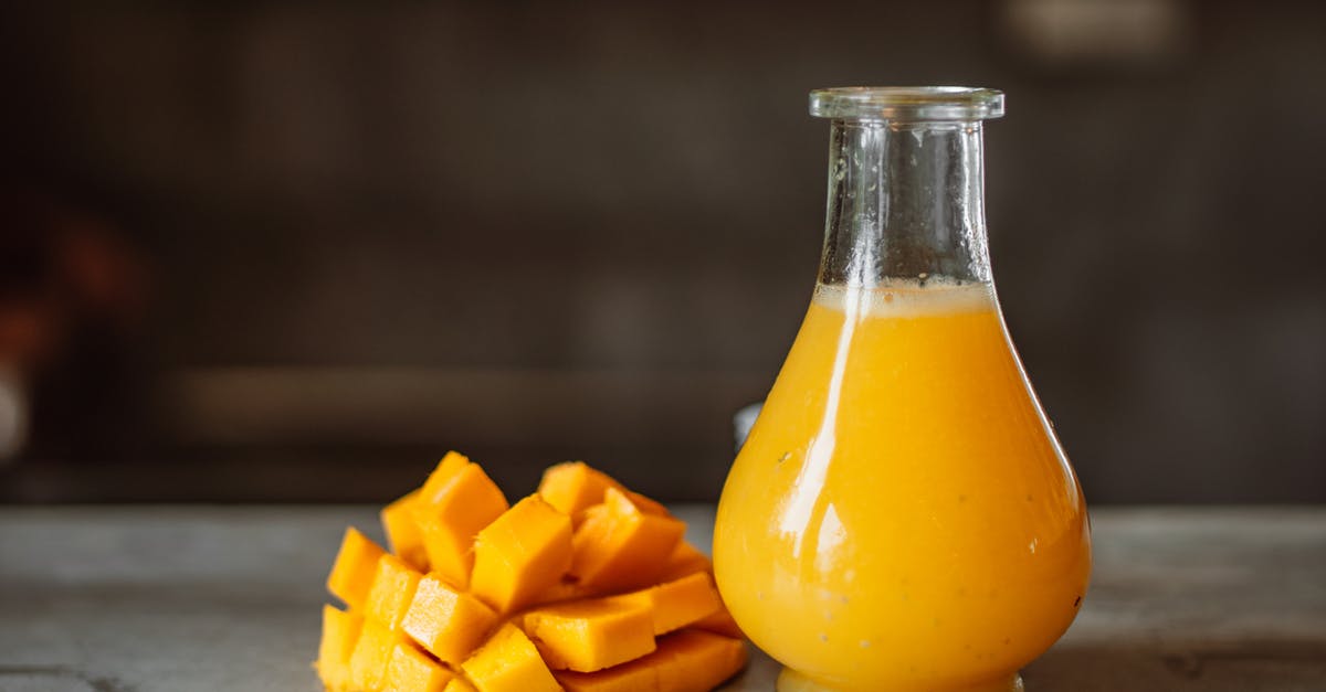 How much juice can a mango yield if run through a juicer? - Mango Juice in Clear Glass Bottle
