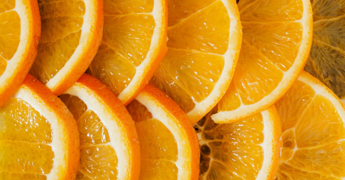 How much juice can you get from an orange? - Top view of delicious sliced oranges arranged near each other as minimalist background of organic nutrition