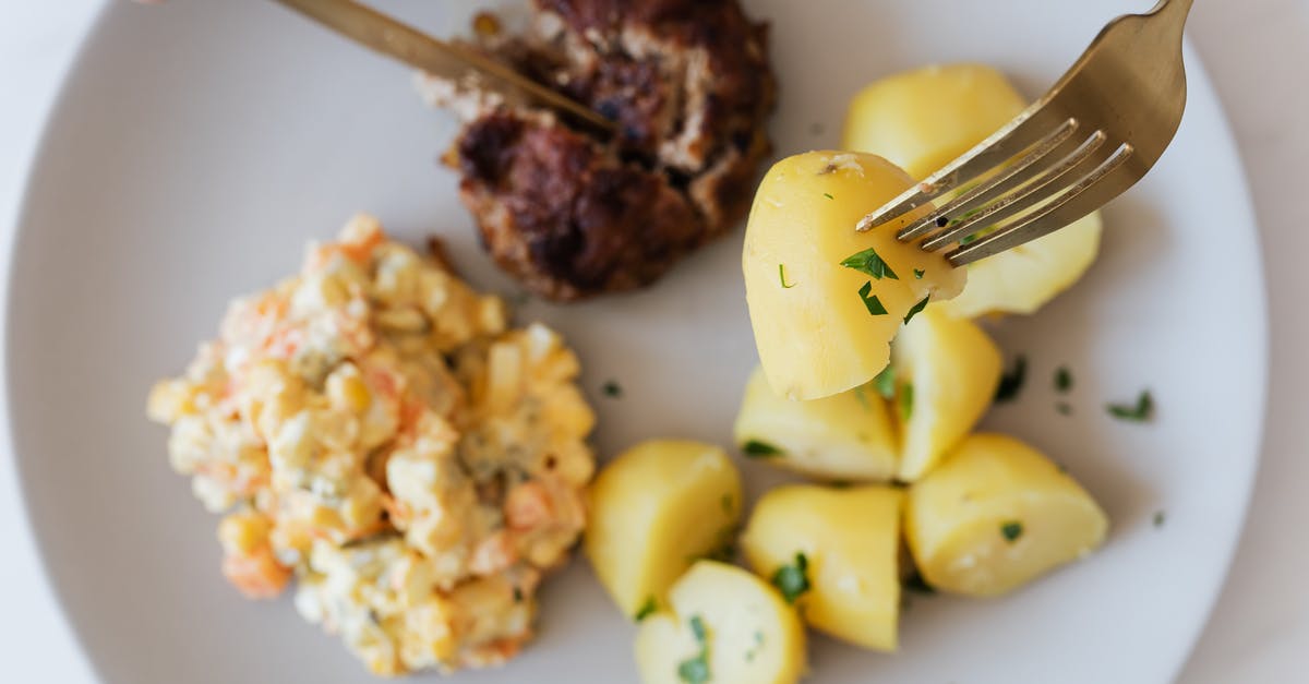 How much meat should I serve per person? - Plate with boiled potatoes Russian salad and meat cutlet