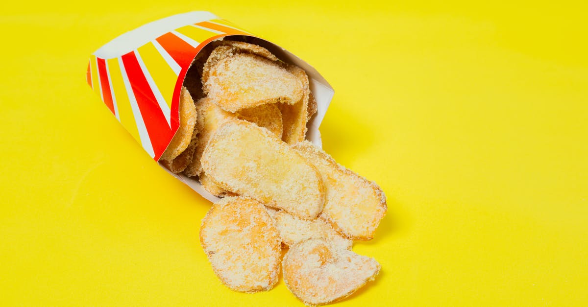 How much potato to add to reduce saltiness - Delicious chips on yellow background