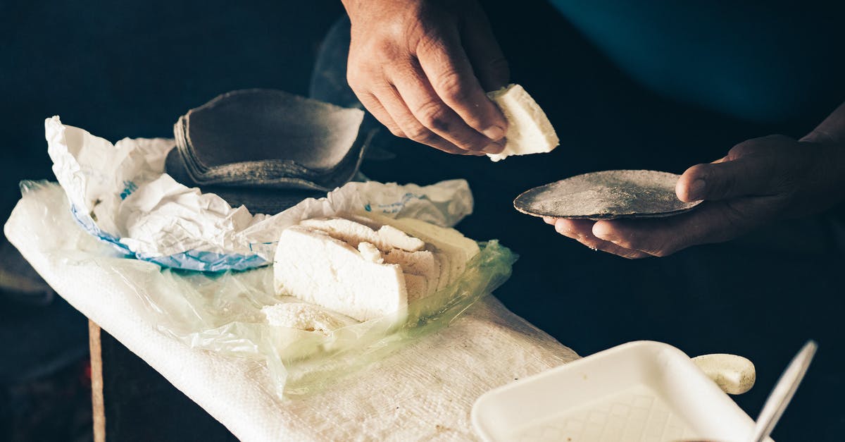 How much vinegar can I safely add to bread dough? - Man putting slice of cheese on tortilla