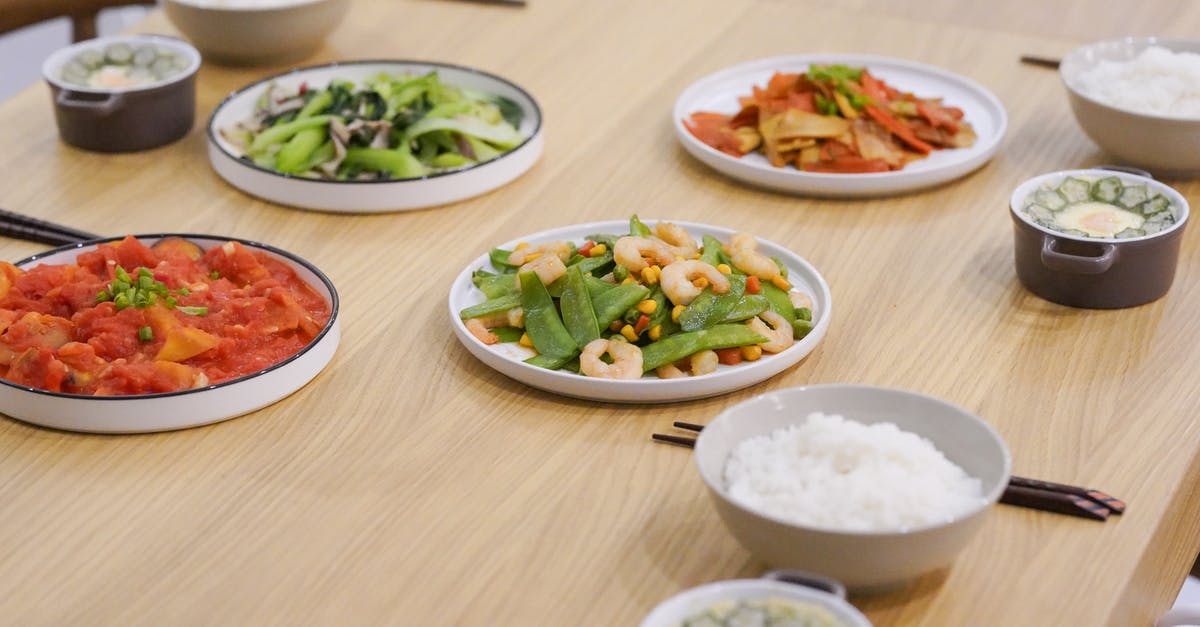 How much water to add to rice cooker when cooking brown rice? - Three Bowls of Rice and Four Vegetable Meals on the Table