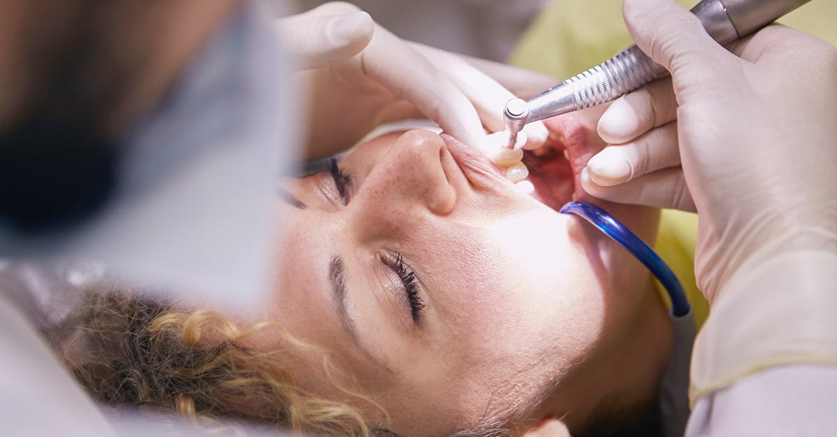 how often is cleaning done in a professional kitchen? - Woman's Teeth Being Clean By Dentist