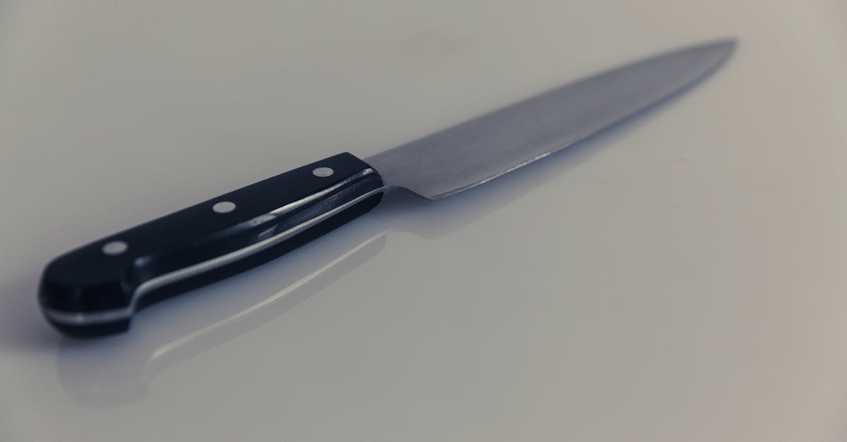 How sharp should a filleting knife be? - Black Handle Knife on White Table