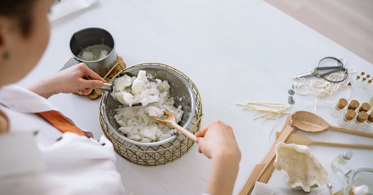 How should Dashi made with kelp and bonito flakes smell? - A Person Scooping White Flakes with an Scooper 