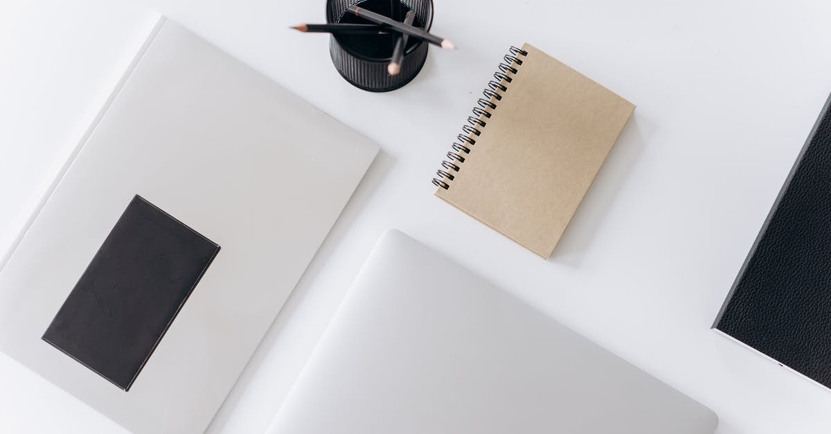 How should I manage my fridge? - Netbook with planner and jotter placed near pencils on desk