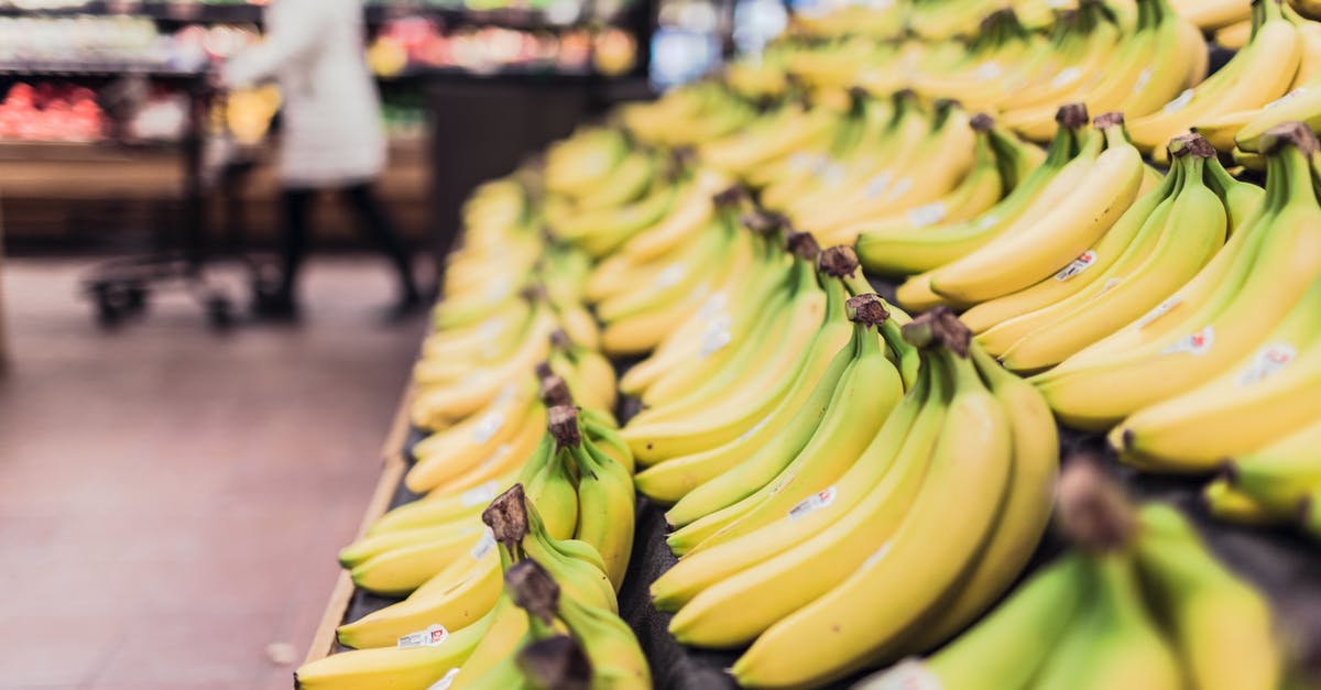 How should I organize my fruits for storage? - Shallow Focus Photography of Bananas