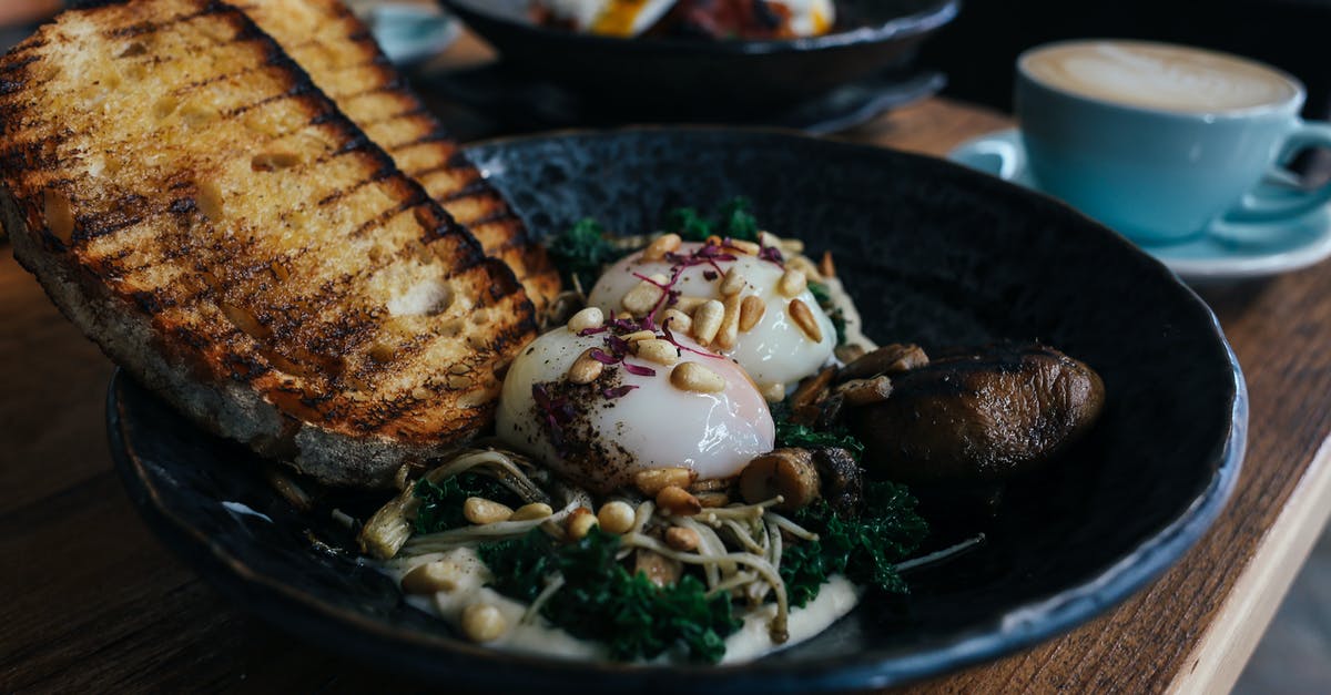 How should I poach an egg? - Grilled Fish on Black Ceramic Plate