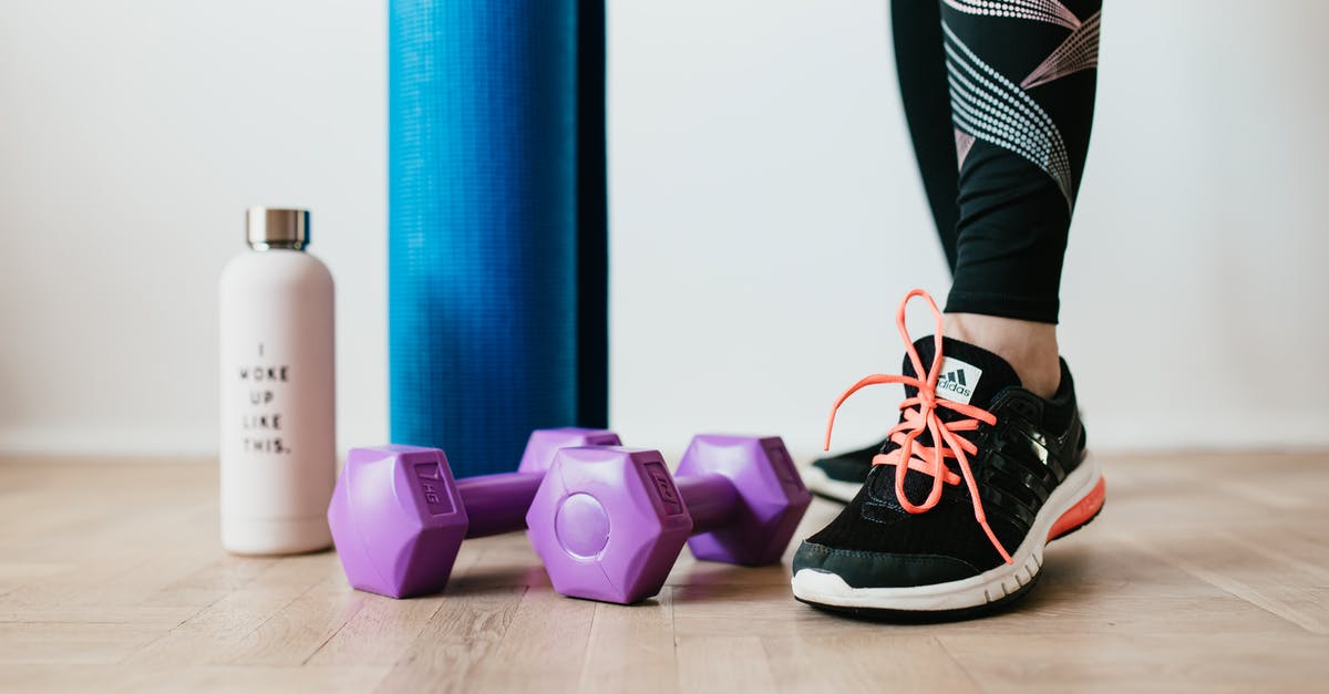 How should I prepare venison hind leg sous vide? - Crop sportswoman wearing sneakers and black leggings standing with sport mat on wooden floor near dumbbells and water bottle before exercising indoors