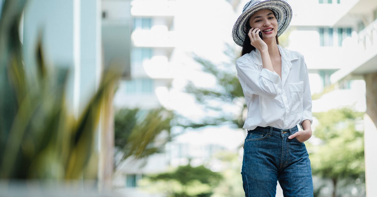 How should I use extra summer squash? - Positive stylish young female talking on cellphone on city street