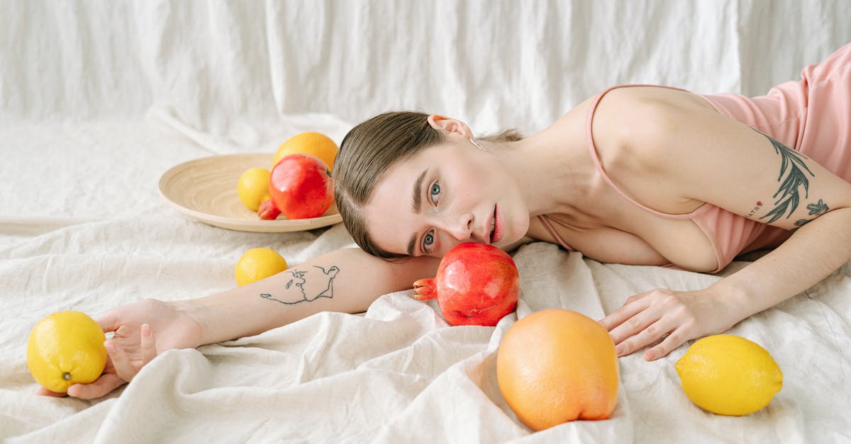 How should pomegranates be stored? - A Woman Holding a Lemon While Lying Down