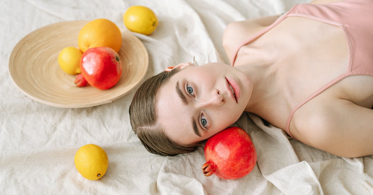 How should pomegranates be stored? - Woman Lying on White Linen Beside Fruits