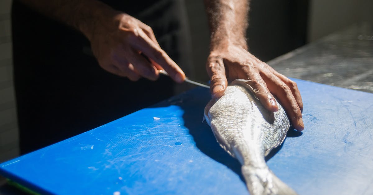 How should swordfish be prepared? - Person Holding White Textile on Blue Table