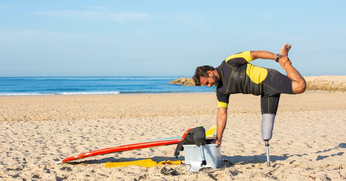 How to add water/milk to the sunny side up eggs? - Side view of male in wetsuit and with artificial limb stretching leg holding on box while preparing for surfing