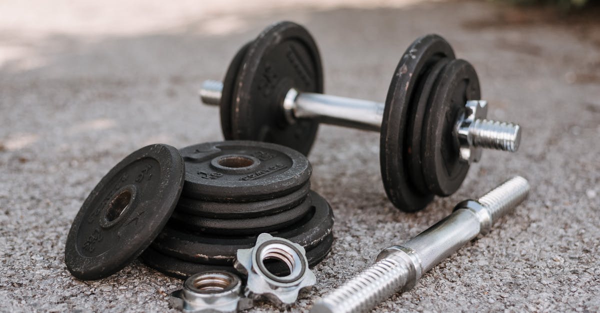 How to adjust stewing time for different weights of meat? - Heavy adjustable dumbbell near cast iron plates and hexagonal collars with stainless steel bar on pavement